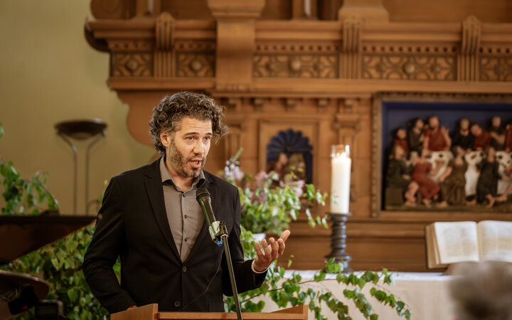 Patrick Telligmann am Rednerpult der Dorfkirche Herzfelde