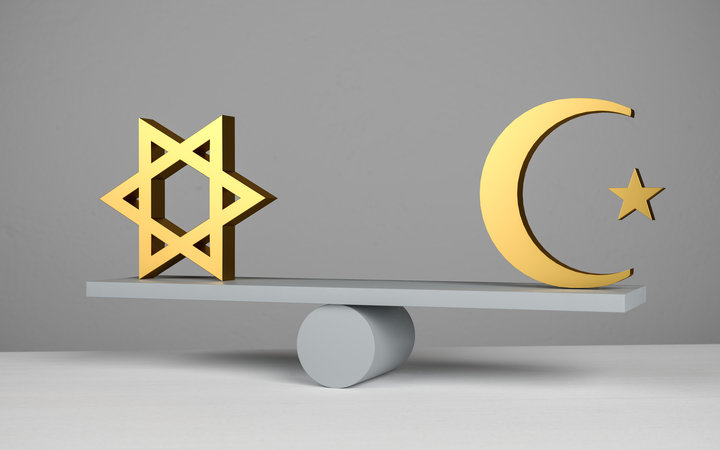 A jewish star of david and an islamic star and crescent symbol on a seesaw / scale