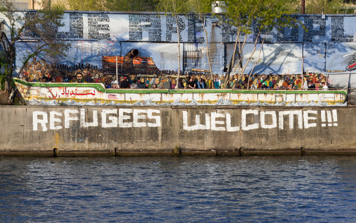 Refugees welcome graffiti and refugee boat in Berlin