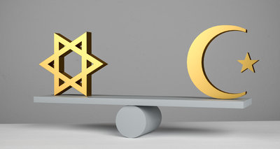 A jewish star of david and an islamic star and crescent symbol on a seesaw / scale