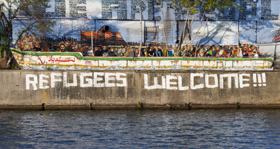 Refugees welcome graffiti and refugee boat in Berlin