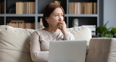 Pensive middle-aged woman look in distance pondering